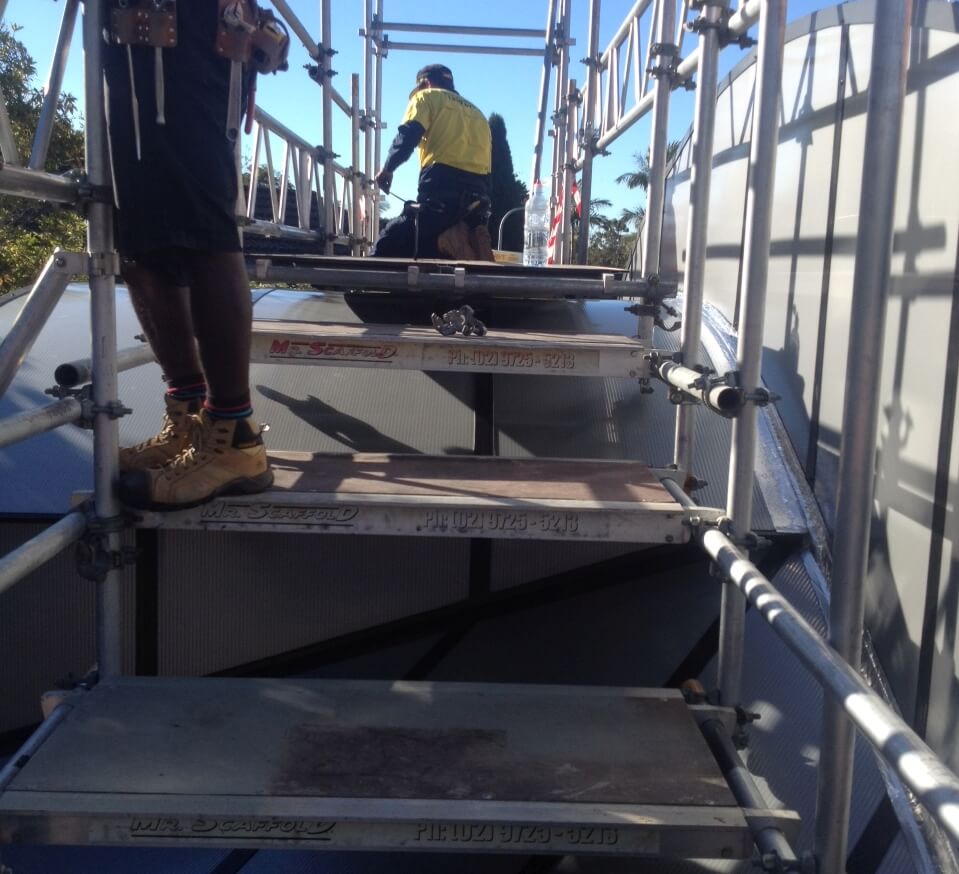 scaffolding platforms as steps follow the roof curve